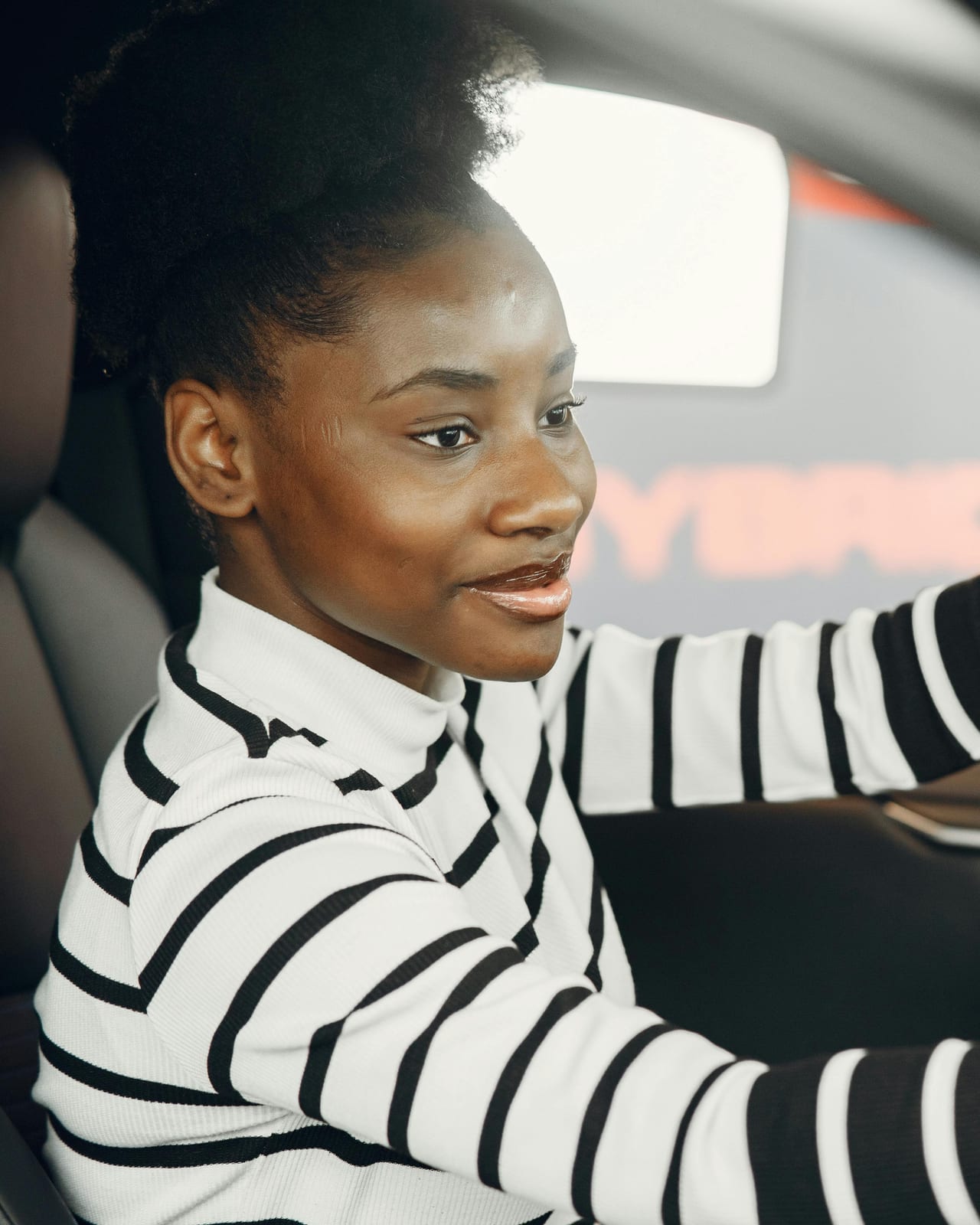 A QuickLyft Founding Driver behind the wheel of her own car, in full control of her route and her schedule